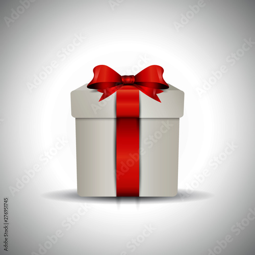 Decorative gift box with red bow and long ribbon.