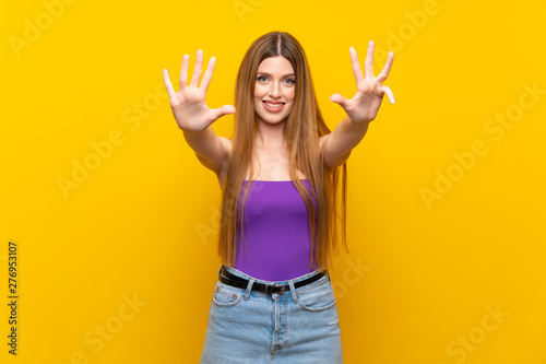 Young woman over isolated yellow background counting nine with fingers