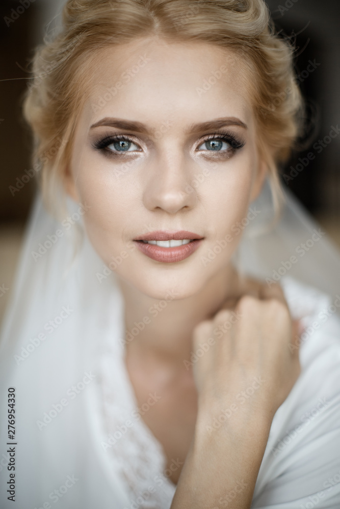 Closeup portrait of a bride's face. She is looking at the camera.