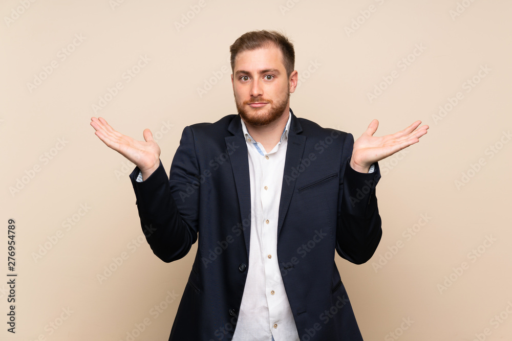 Blonde man over isolated background making doubts gesture Blonde man over isolated background making doubts gesture