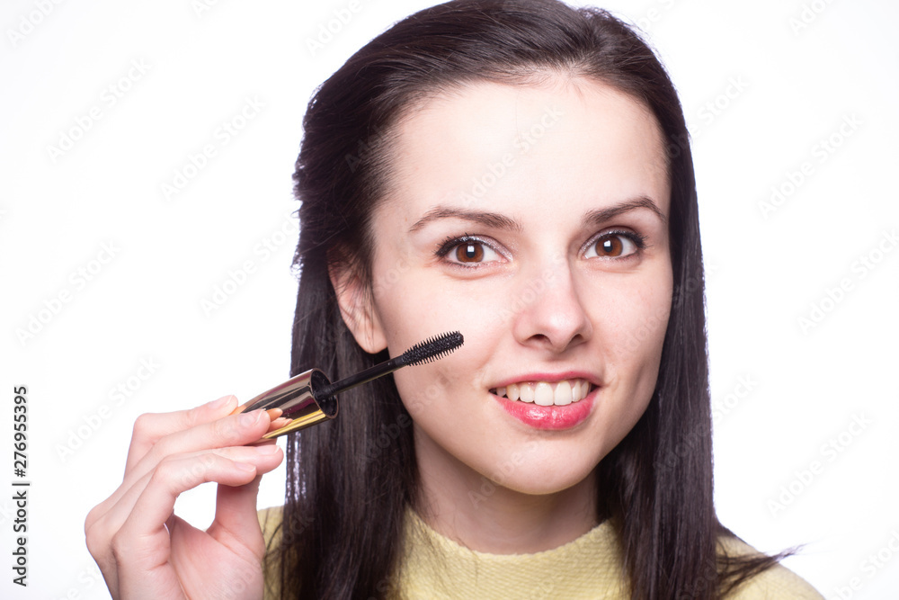 attractive young woman doing makeup