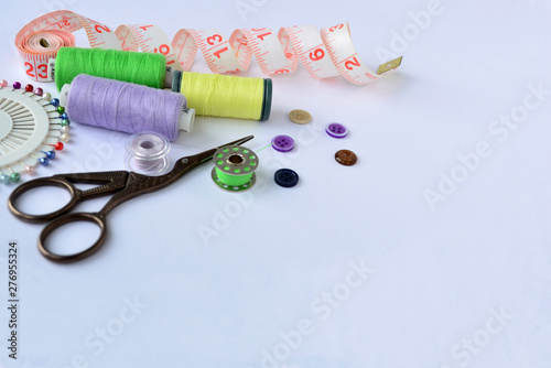 Set of tailoring tools and accessories on light background © Ирина Соколова