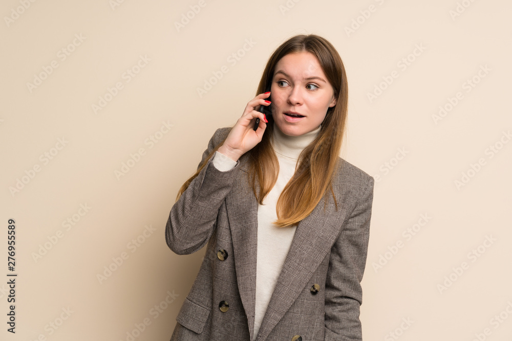 Young business woman keeping a conversation with the mobile phone Young business woman keeping a conversation with the mobile phone
