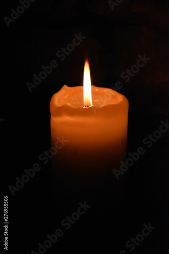 Hot flames of candles in dark room