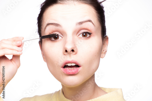 beautiful young girl close up portrait paints eyelashes