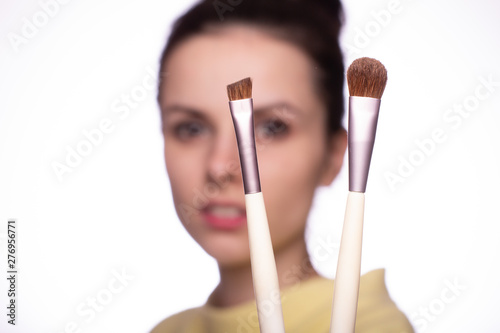 attractive young woman doing makeup