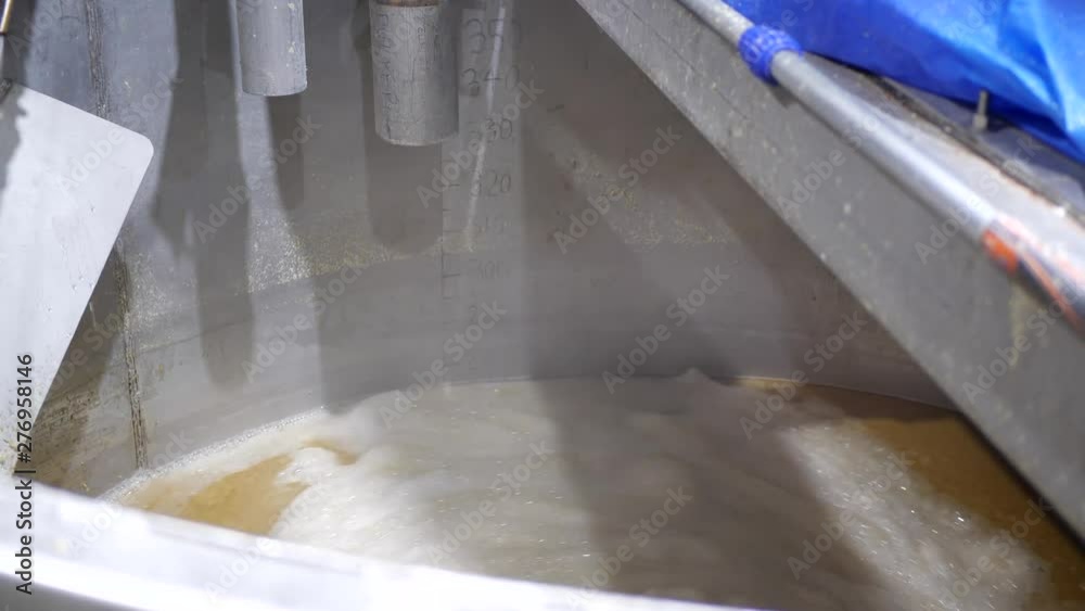 Still close up shot of industrial liquid being mixed while water is being sprayed. Still close up shot of industrial liquid being mixed while water is being sprayed.