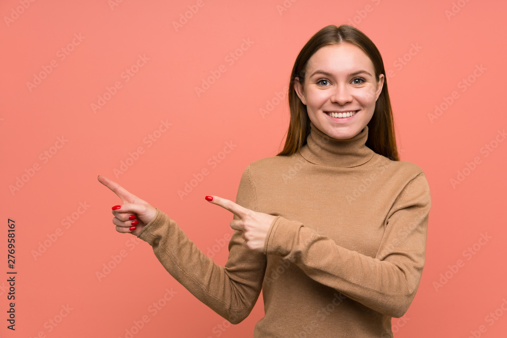 Young woman over colorful background pointing finger to the side Young woman over colorful background pointing finger to the side