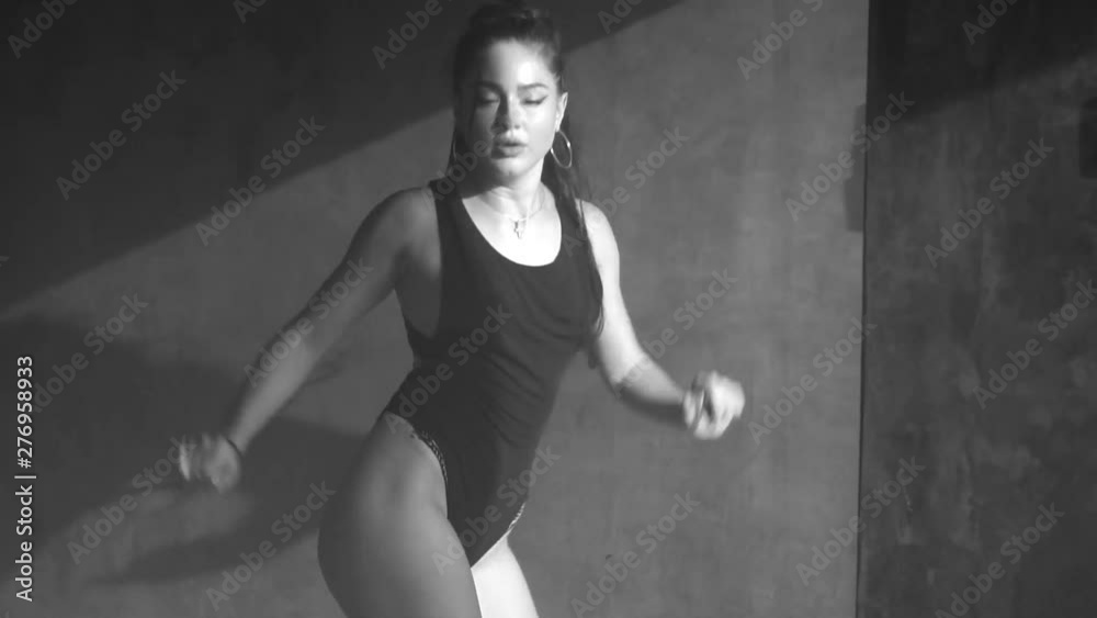 Beautiful sensual woman in black body suit dancing in hazy studio with grey concrete walls - black and white video Beautiful sensual woman in black body suit dancing in hazy studio with grey concrete walls - black and white video