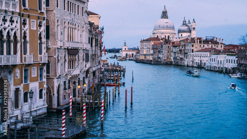 Beautiful view on Basilica di Santa Maria della Salute in golden evening light at sunset in Venice, Italy