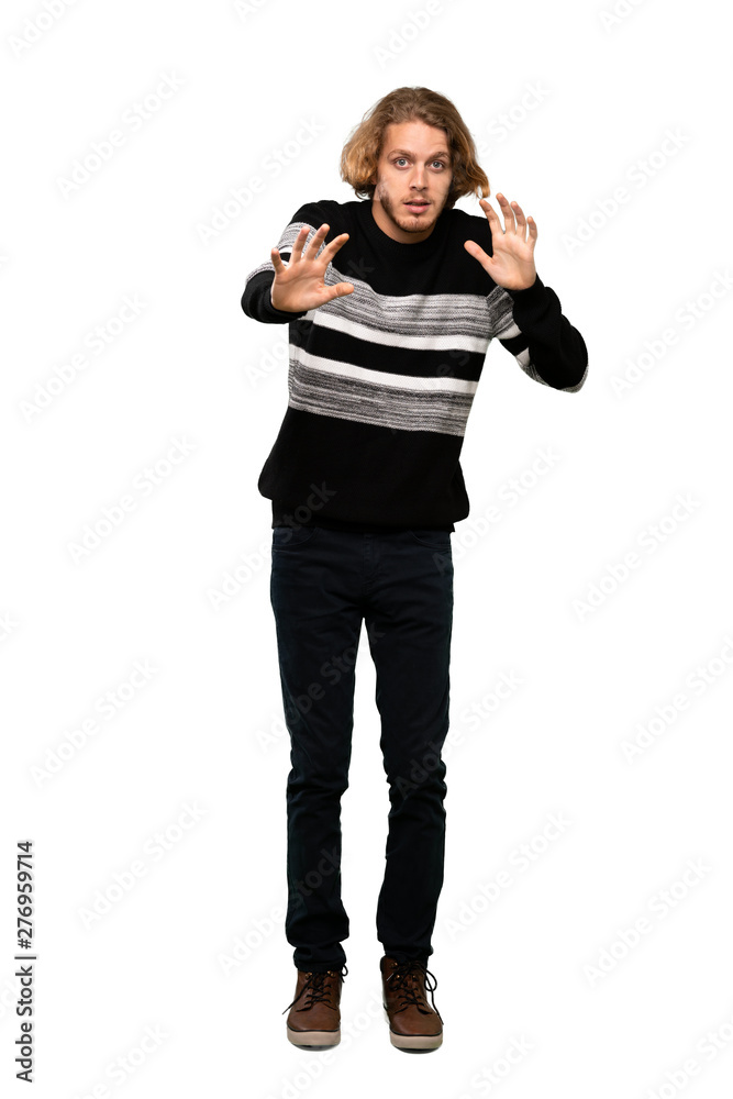Full-length shot of Blonde man nervous stretching hands to the front over isolated white background Full-length shot of Blonde man nervous stretching hands to the front over isolated white background