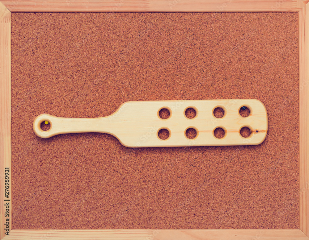 Wooden paddle for spanking on cock board on the wall. Domestic discipline.  Traditional corporal punishment implements. bdsm toys, adult games,  old-fashioned discipline foto de Stock | Adobe Stock