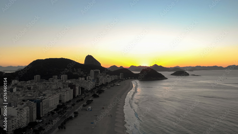 Copacabana neighbourhood and beach at sunrise with the Sugarloaf mountain in the background