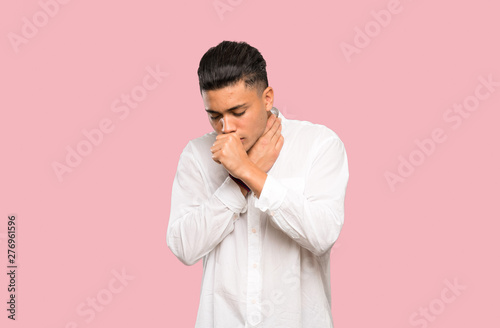 Young man is suffering with cough and feeling bad on colorful background