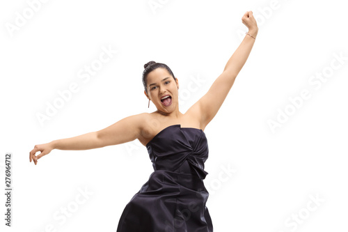 Young woman in an elegant dress jumping and gesturing happiness