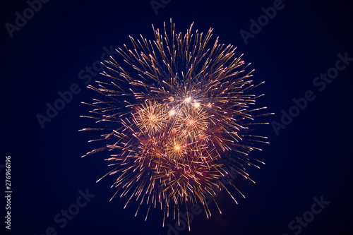 Cheap beautiful large fireworks, white-yellow, in the night sky, background texture