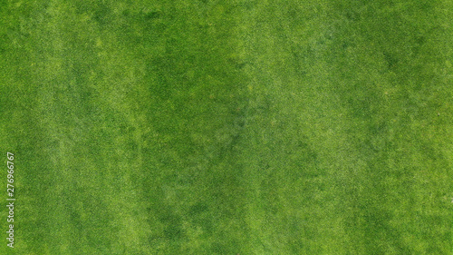 Aerial. Green grass texture background. Top view from drone.