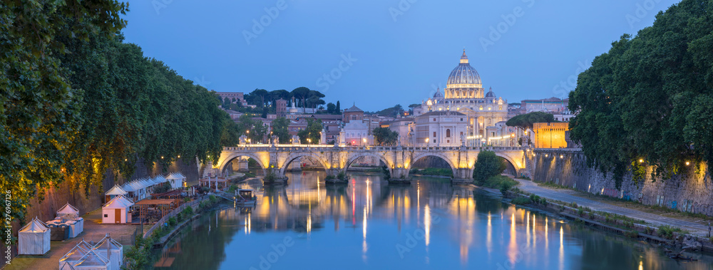 Panorama of Rome landmarks with bridge and Cathedral Saint Peter in evening lights 
