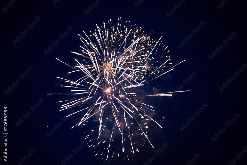 Cheap bright sparkling fireworks, white, with haze, in the night sky, background texture Cheap bright sparkling fireworks, white, with haze, in the night sky, background texture