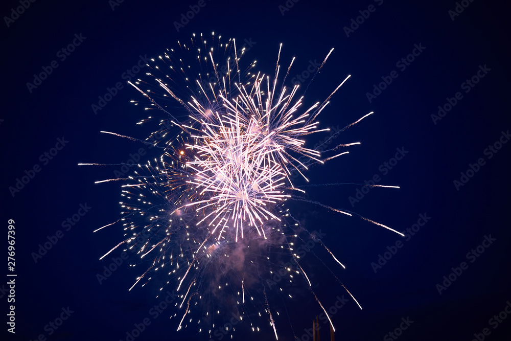 Cheap bright sparkling fireworks, pink, with haze, on the night sky, background texture Cheap bright sparkling fireworks, pink, with haze, on the night sky, background texture