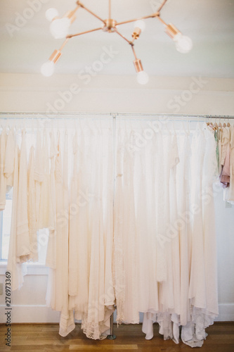 wedding dresses hanging togerher photo