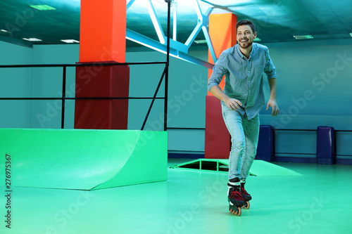 Man having fun at roller skating rink. Space for text © New Africa