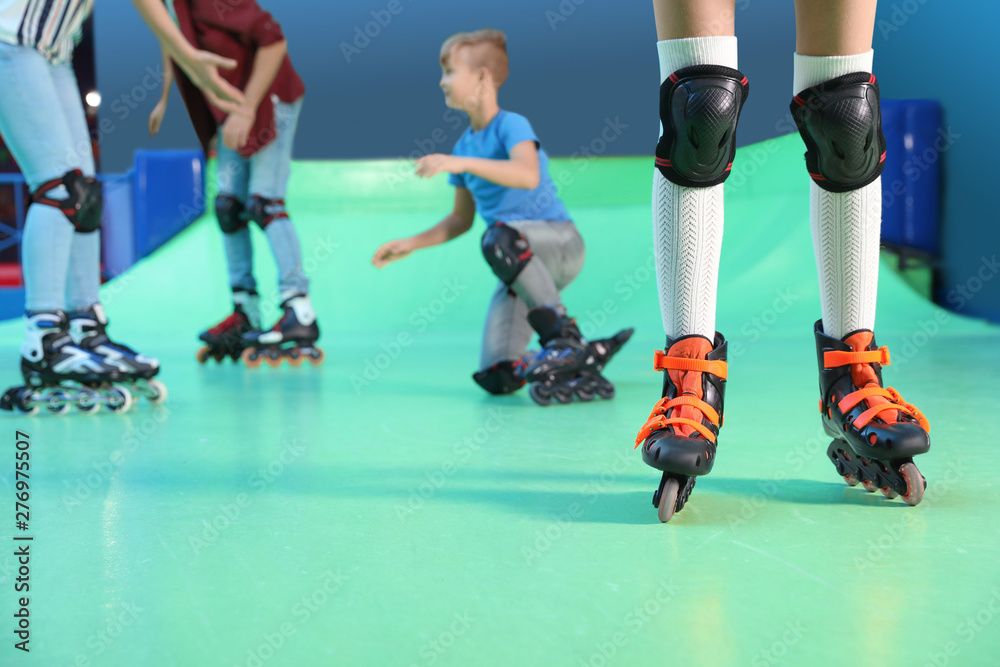 Naklejka premium Family having fun at roller skating rink, closeup