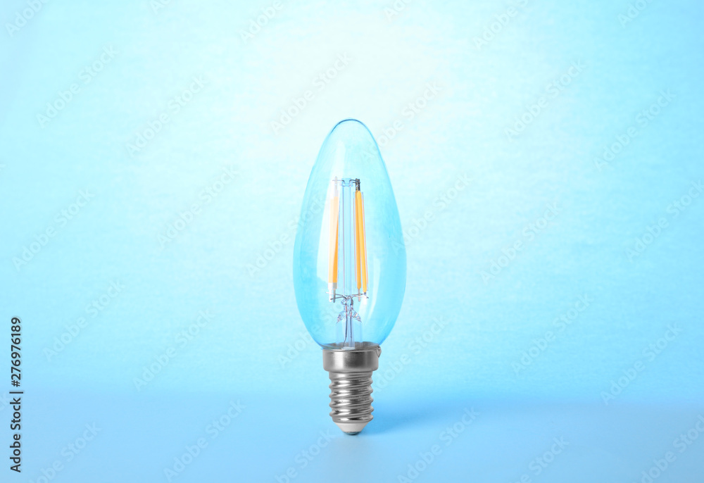 New modern lamp bulb on light blue background New modern lamp bulb on light blue background