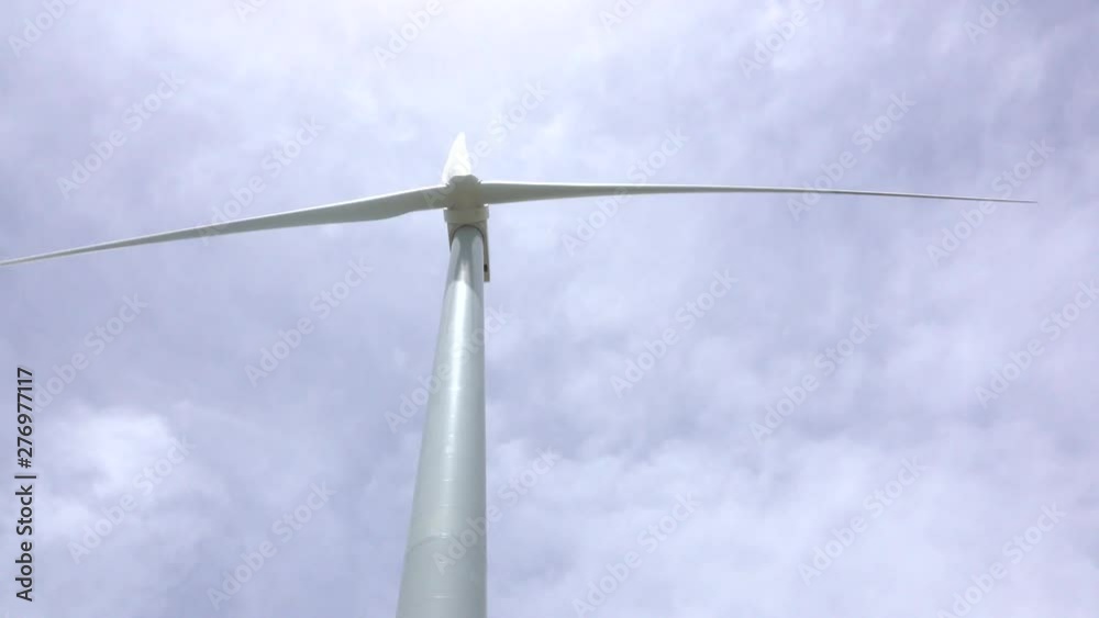 Close up view of a wind turbine generating electricity with every turn Close up view of a wind turbine generating electricity with every turn