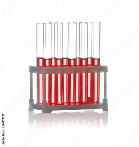 Test tubes with liquid samples in rack on white background. Chemistry glassware