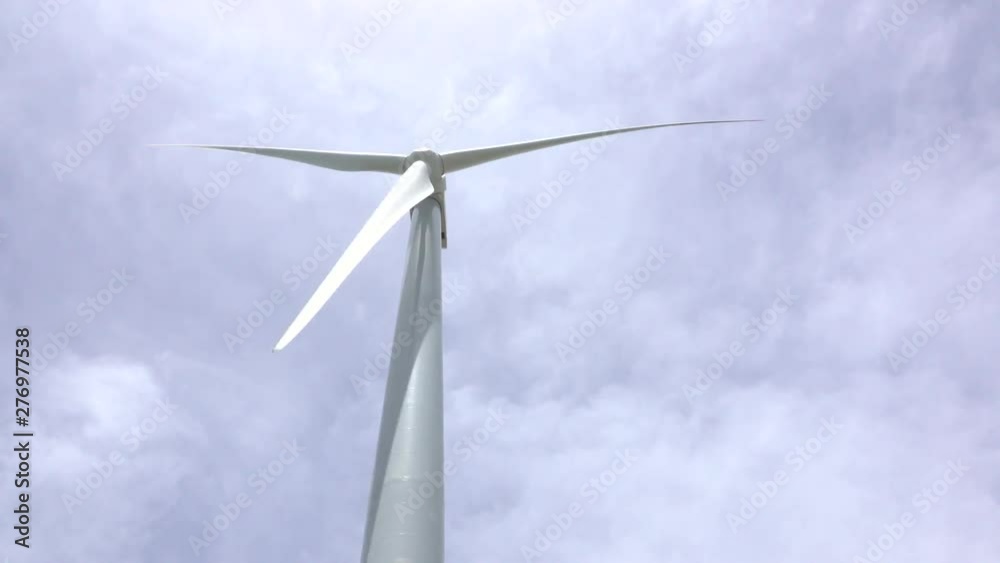 Close up view of a wind turbine generating electricity with every turn Close up view of a wind turbine generating electricity with every turn