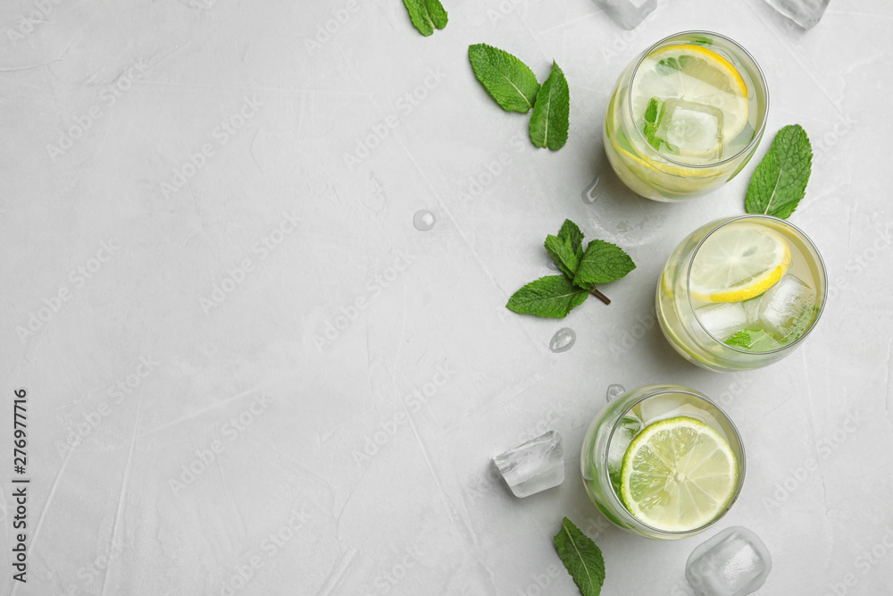 Flat lay composition with glasses of refreshing lemonade on grey background, space for text. Summer drink Flat lay composition with glasses of refreshing lemonade on grey background, space for text. Summer drink