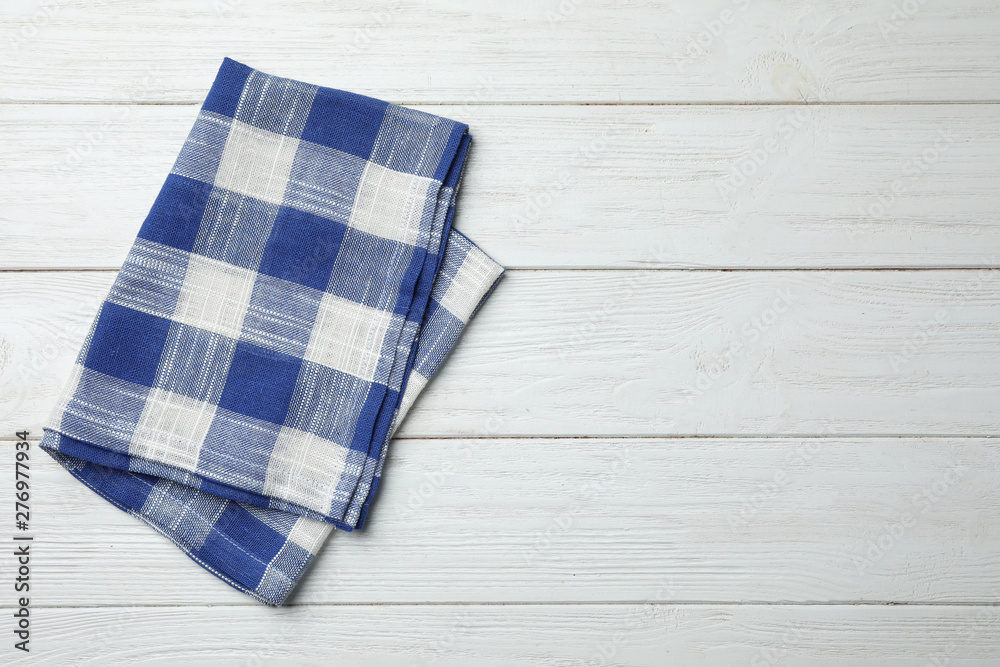Folded kitchen towel on white wooden table, top view. Space for text Folded kitchen towel on white wooden table, top view. Space for text