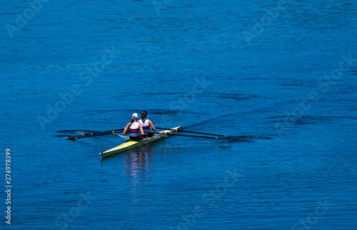 Two Female Rowers In A Double Racing Boat With Synchronous Oar Stroke