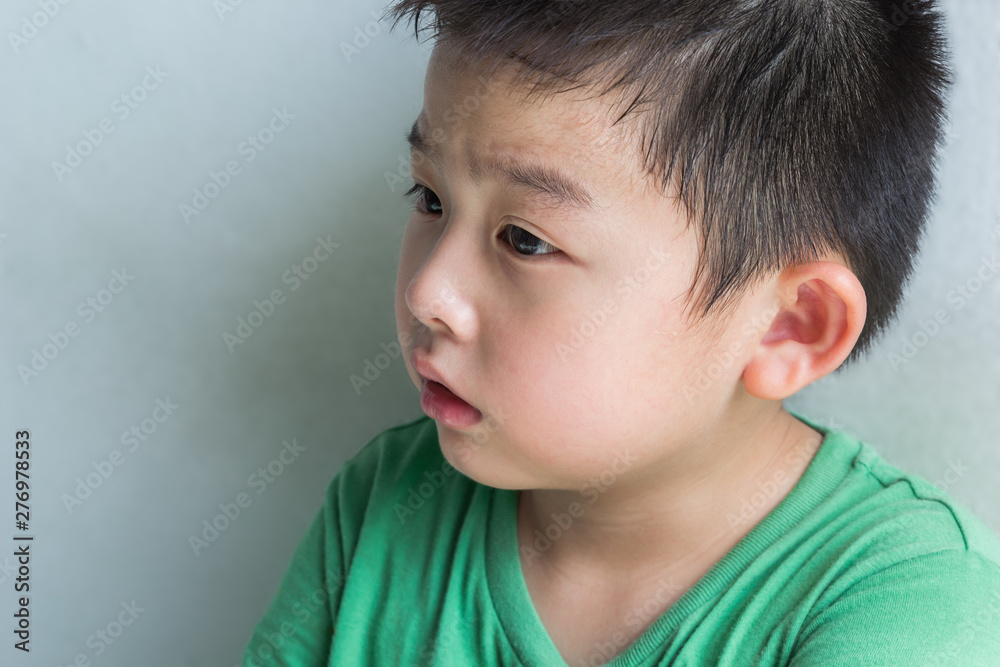 Cute boy in green shirt feel sad and tired from crying, close up portrait Cute boy in green shirt feel sad and tired from crying, close up portrait