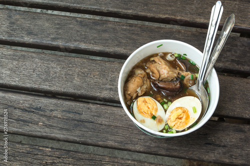 One Chinese roll noodle soup with boiled egg on the wood table