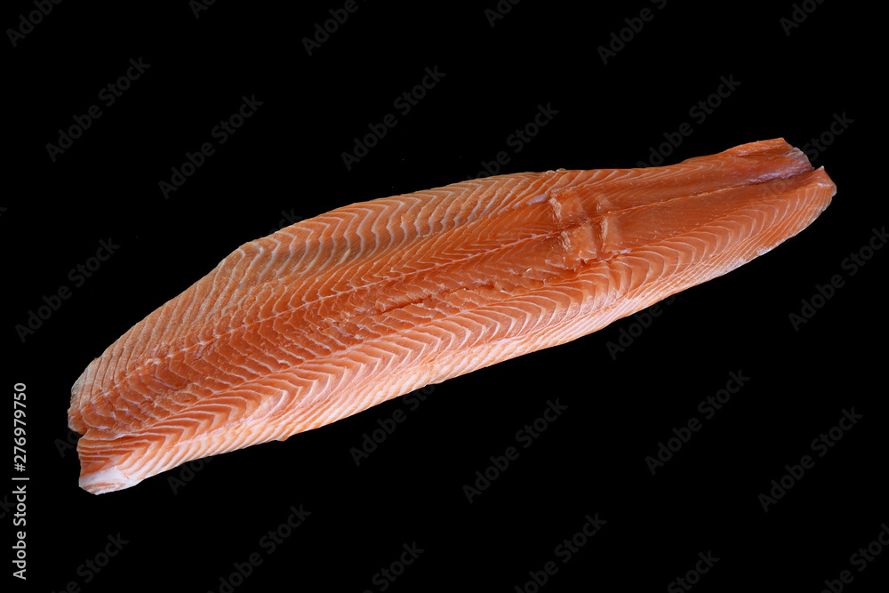 Raw salmon fillet over black background Raw salmon fillet over black background