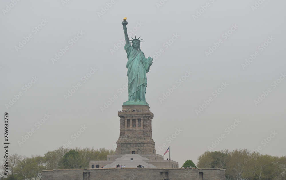 Statue of Liberty (American Flag to the right) on an Overcast Spring Morning