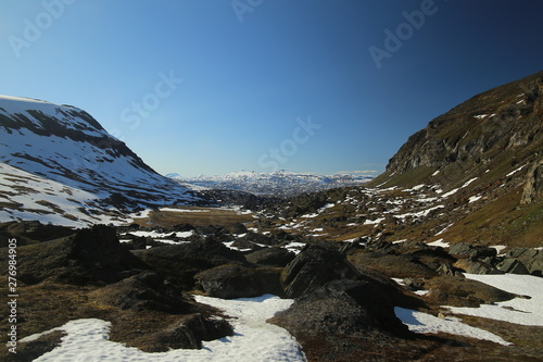 Snow patches and rocks at the valley Karkevagge in Northern Sweden