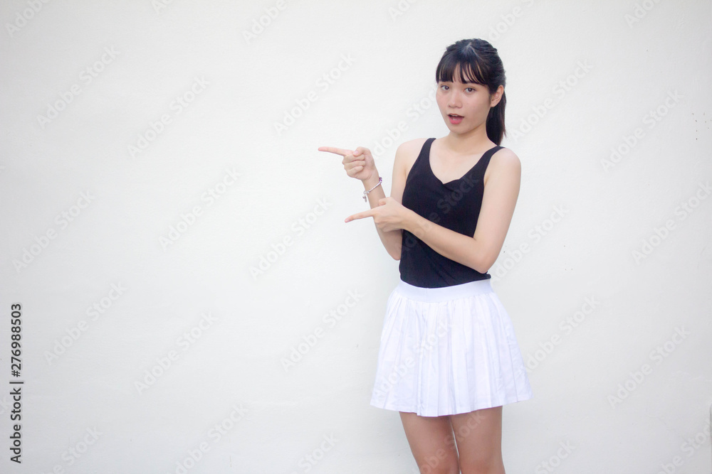 Portrait of thai adult beautiful girl black shirt white skirt pointing Portrait of thai adult beautiful girl black shirt white skirt pointing