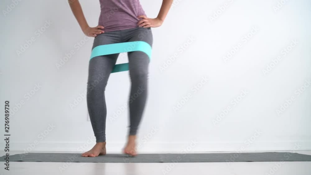 Resistance band exercises with fabric elastic equipment. Crab walk squat exercise fit Asian fitness woman training at home. Lateral band walk,
