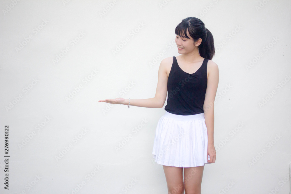 Portrait of thai adult beautiful girl black shirt white skirt show hand Portrait of thai adult beautiful girl black shirt white skirt show hand