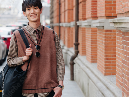 Photography Portrait of a handsome Chinese young man with Korean style clothes smiling and l