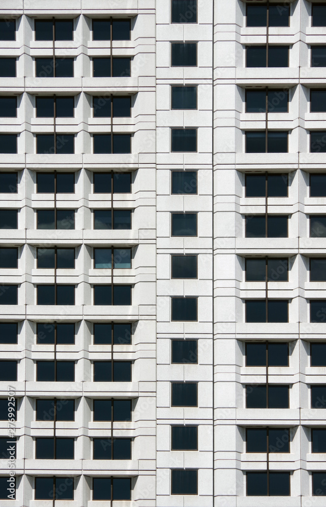 Close view of a section of a big city skyscraper facade similar to a beehive Close view of a section of a big city skyscraper facade similar to a beehive