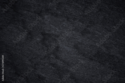 Dark grey black slate background or natural stone texture.