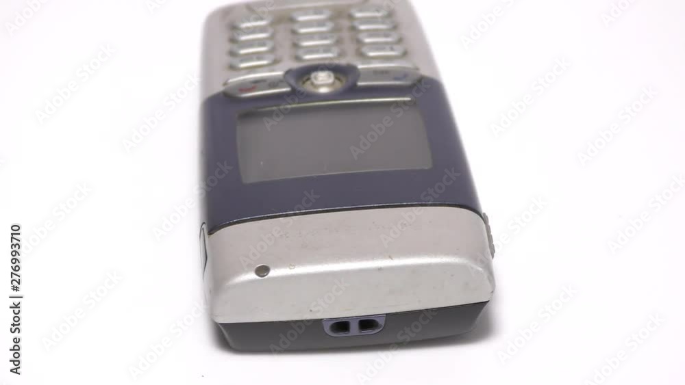 An old mobile phone with buttons and keypad on white An old mobile phone with buttons and keypad on white