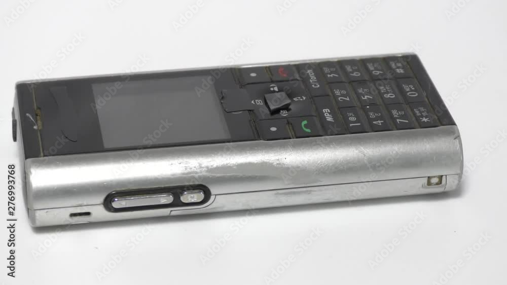 The old and used phone which is waste moving in motion on white The old and used phone which is waste moving in motion on white