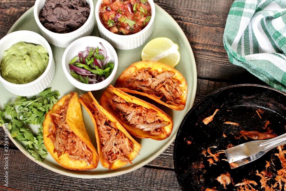 tacos with pork long languor and different sauces, salsa, guacamole, ketchup, cilantro. fried tortilla cakes tacos with pork long languor and different sauces, salsa, guacamole, ketchup, cilantro. fried tortilla cakes