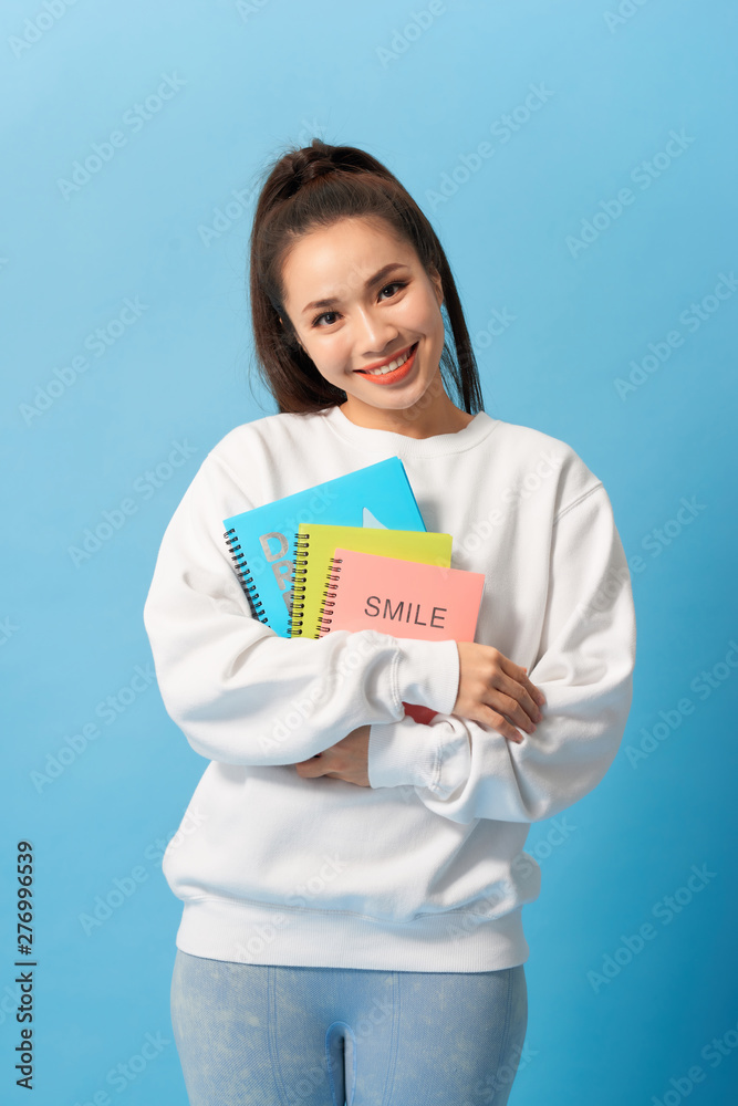 Nice female student smiling and looking at camera Nice female student smiling and looking at camera