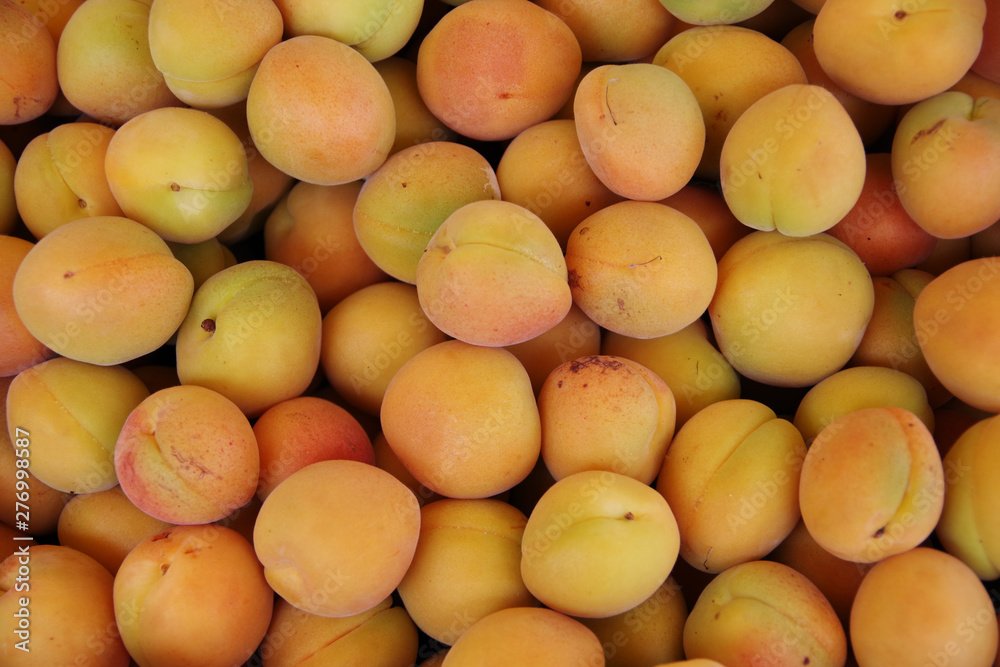 Close up full frame view of fresh apricots displayed for sale at a market stand Close up full frame view of fresh apricots displayed for sale at a market stand